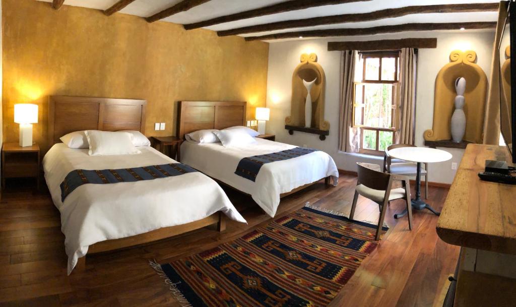 Postel nebo postele na pokoji v ubytování Guayaba Inn Boutique Hotel