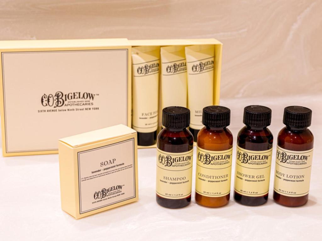 four bottles of cough syrup next to a box at LIBER HOTEL Osaka in Osaka