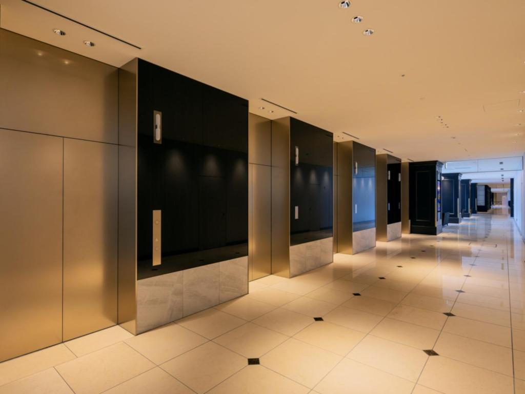a hallway of elevators in a building at LIBER HOTEL Osaka in Osaka