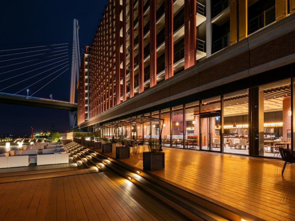 a view of a building with a deck at night at LIBER HOTEL Osaka in Osaka