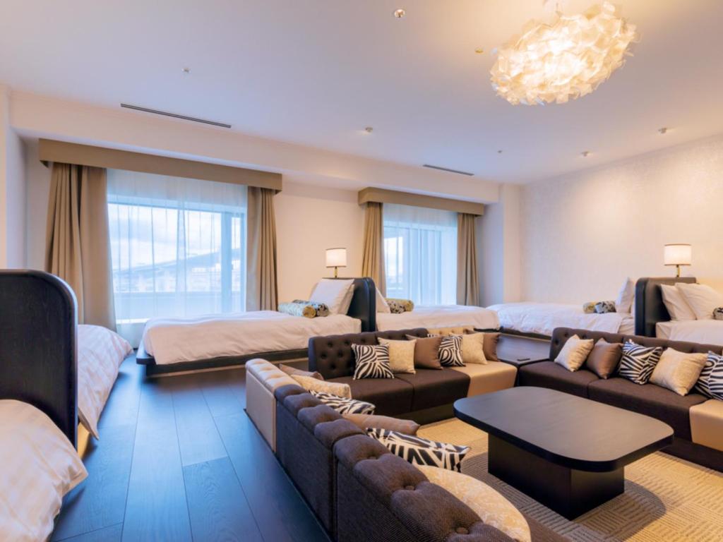 a large living room with couches and a couch at LIBER HOTEL Osaka in Osaka
