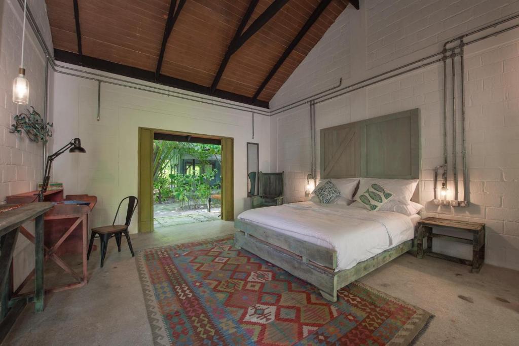 Un pat sau paturi într-o cameră la Mi Lugar Maldives