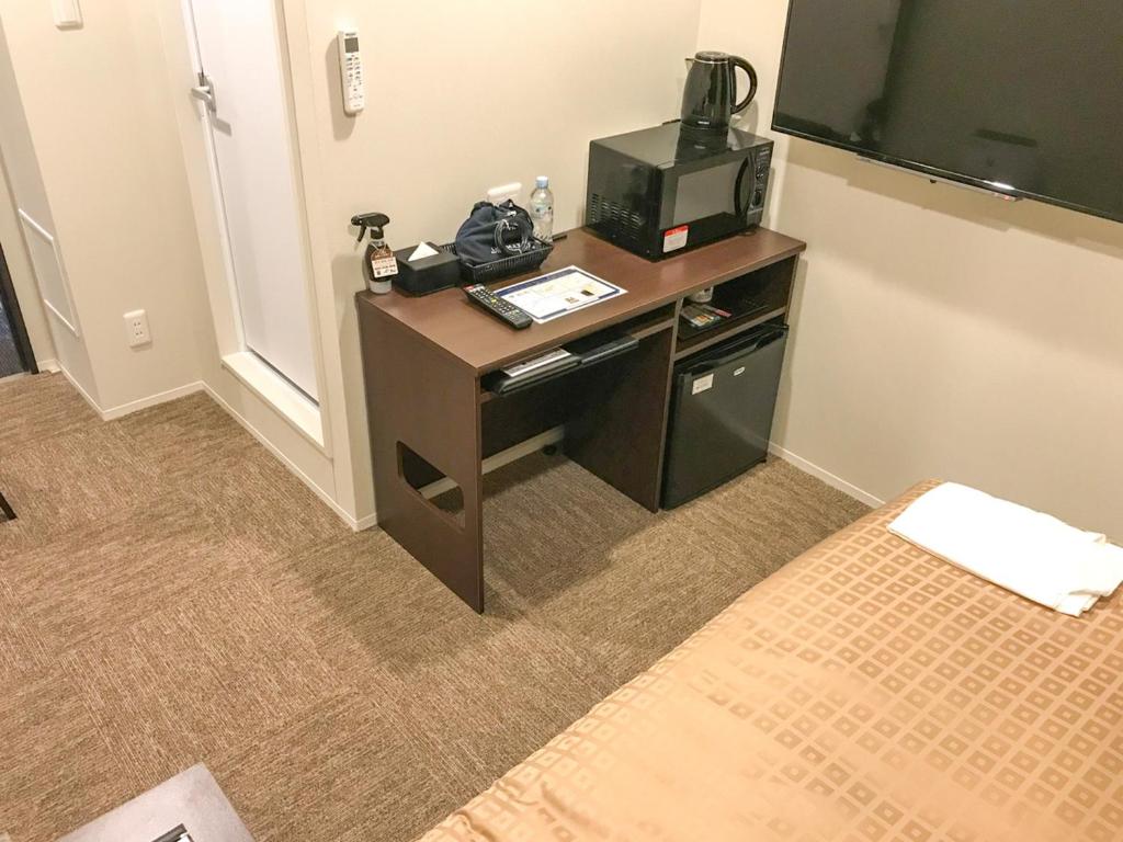 Postel nebo postele na pokoji v ubytování Hotel Livemax Toyama