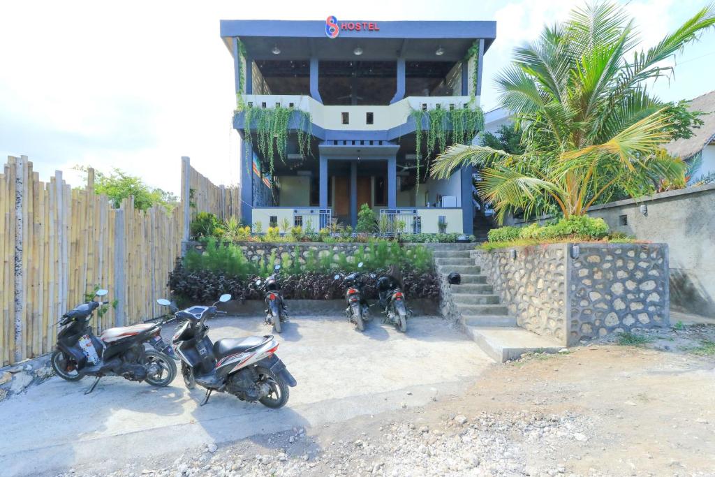 a group of motorcycles parked in front of a house at Hostel Bukit Sangcure in Nusa Penida