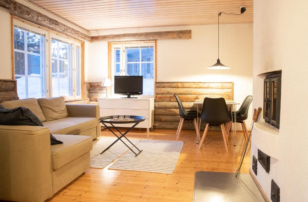 een woonkamer met een bank en een tafel bij Holiday Home Etelärinne E - Ruka Jurmuntie 10 in Kuusamo