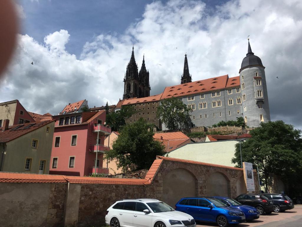 une ville avec des voitures garées devant un bâtiment dans l'établissement Ferienwohnung Mittendrin -Balkon-, à Meissen