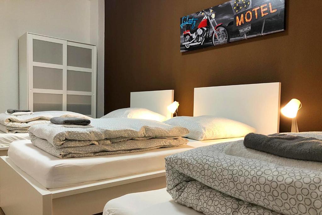 two beds with towels on them in a bedroom at cosy three room apartment with flatscreen TV in Recklinghausen
