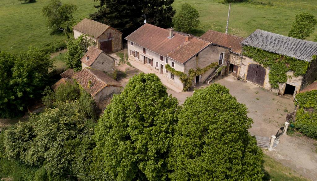 an aerial view of an old house with trees at domaine de crayeux in Les Champs