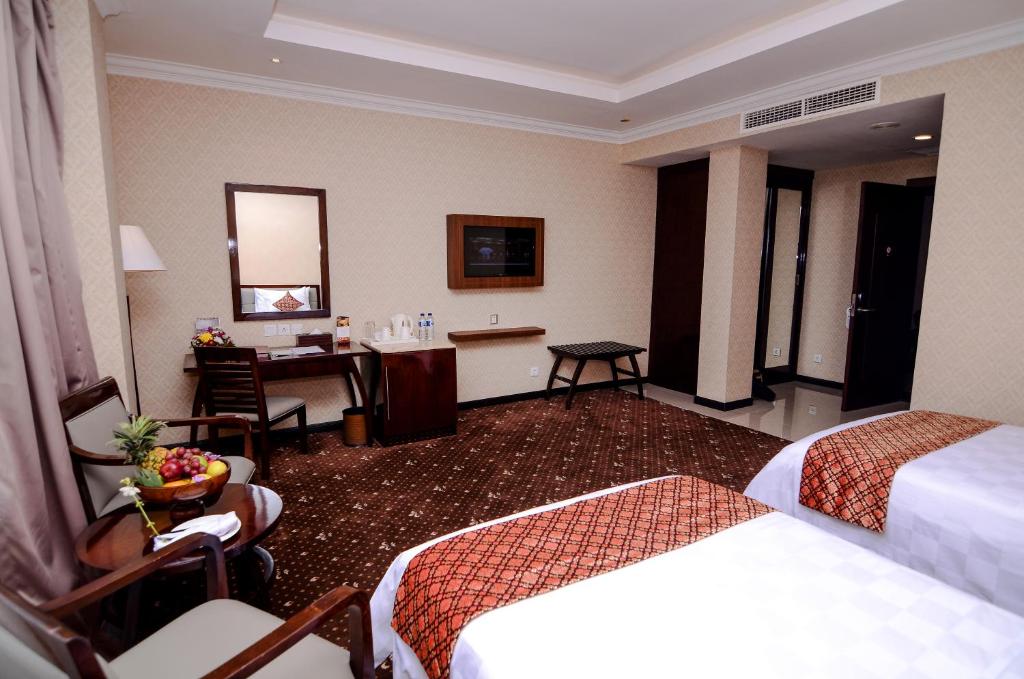 Postel nebo postele na pokoji v ubytování Hermes Palace Hotel Banda Aceh