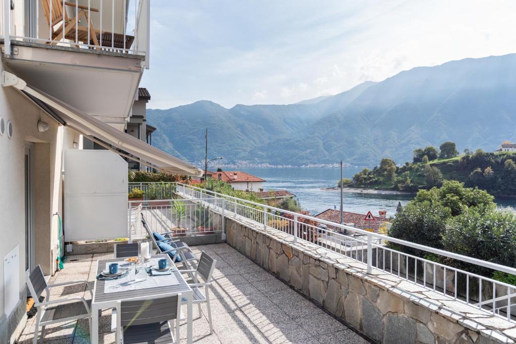 a balcony with a view of the water and mountains at Ossuccio Island View - by MyHomeInComo in Ossuccio