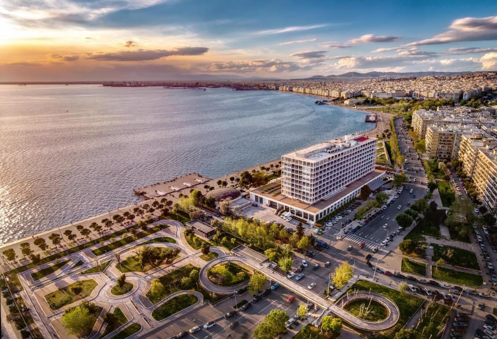 an aerial view of a city and the water at Makedonia Palace in Thessaloniki