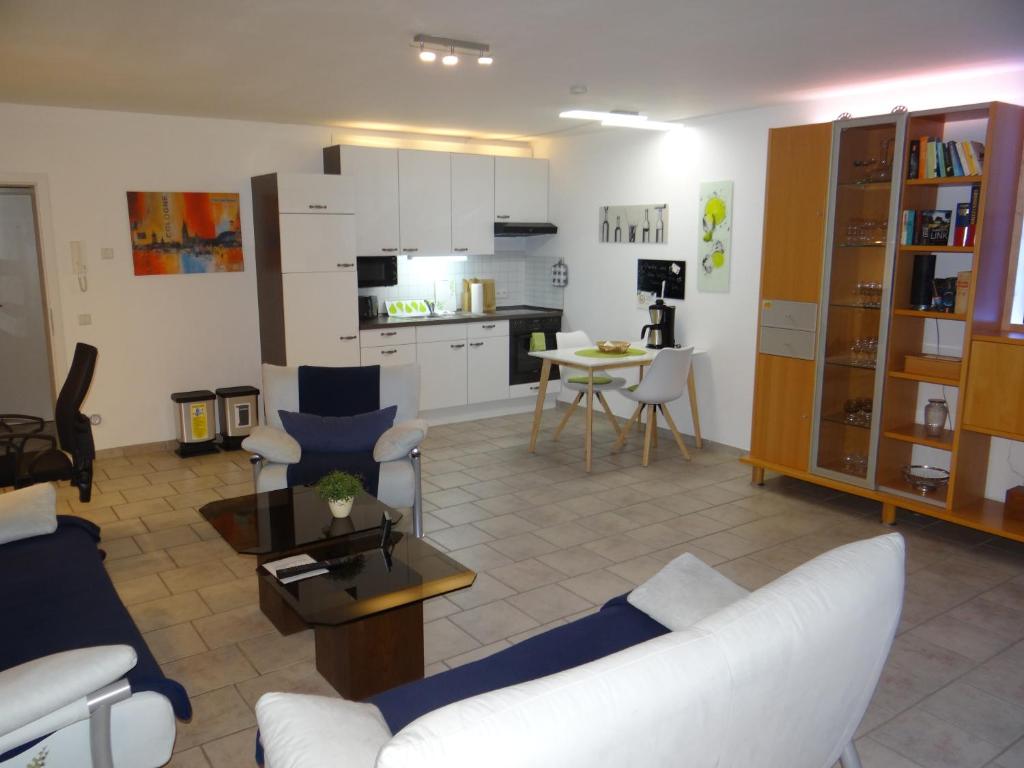 uma sala de estar com um sofá branco e uma cozinha em Beautiful Apartment im Zentrum von Sankt Augustin mit Netflix-Anschluss em Sankt Augustin