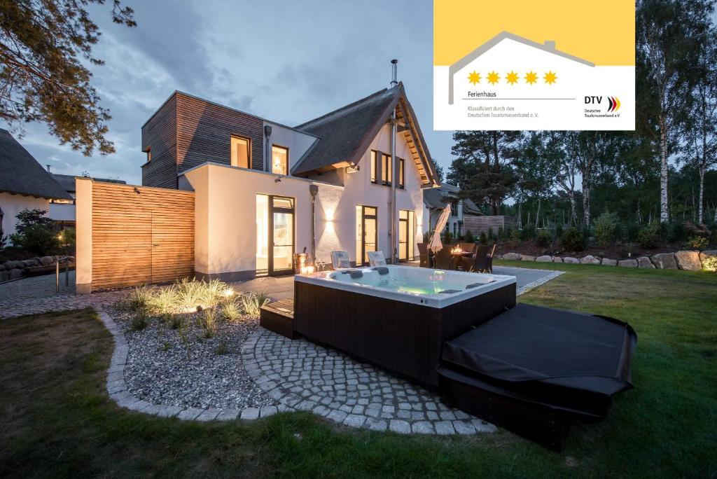 a house with a hot tub in the yard at Kapitaensweg 12 in Ostseebad Karlshagen