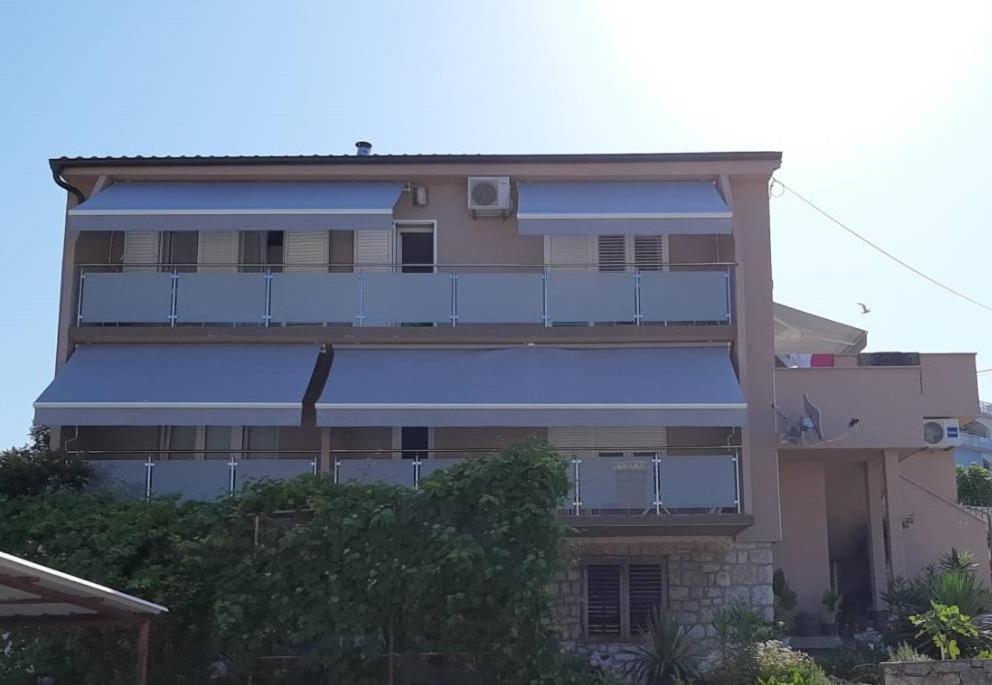a tall building with a blue awning on it at Jelly in Crikvenica