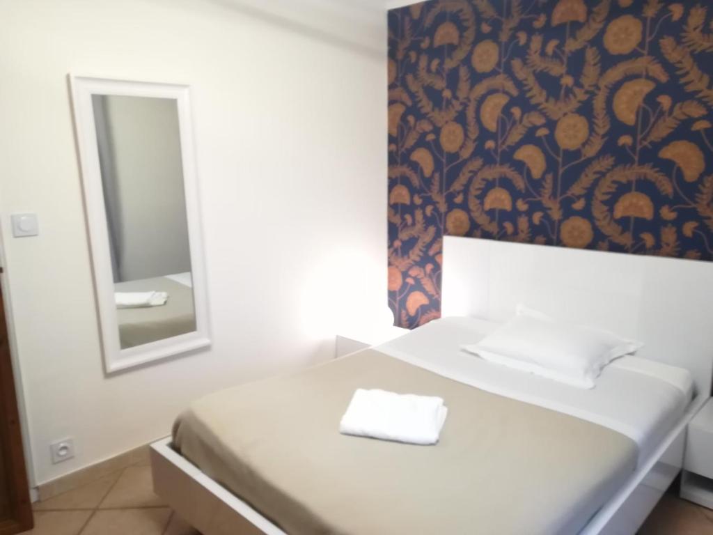 um quarto com uma cama branca e um espelho em Chambre avec tout le confort d'un appartement em Villeneuve-lès-Avignon