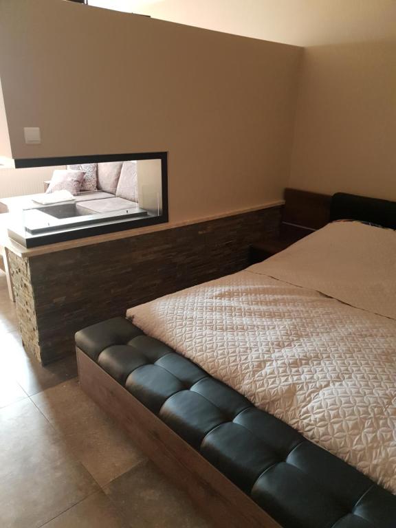 a bedroom with a bed with a mirror on the wall at MOLO APART in Mosty