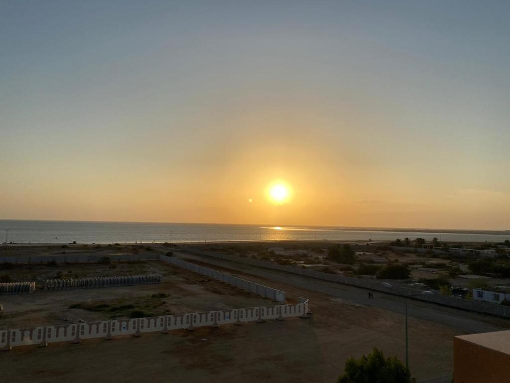 a sunset over the ocean from a building at Fakher Yanbu 3 Furnished Units in Yanbu