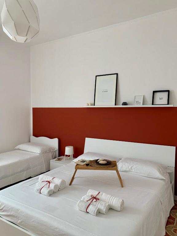 a bedroom with two beds and a table on it at Talìa in Agira