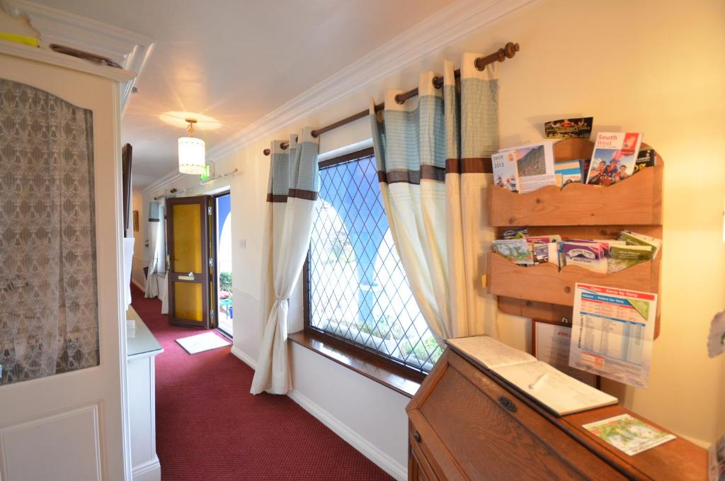 a hallway with a window and a red floor at Gormans Country Home in Killarney