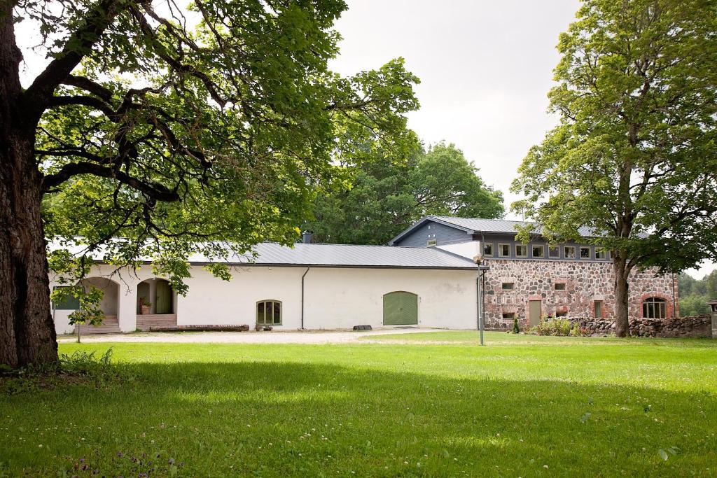 a large white barn with a large grass field at Eistvere Manor Accommodation in Eistvere