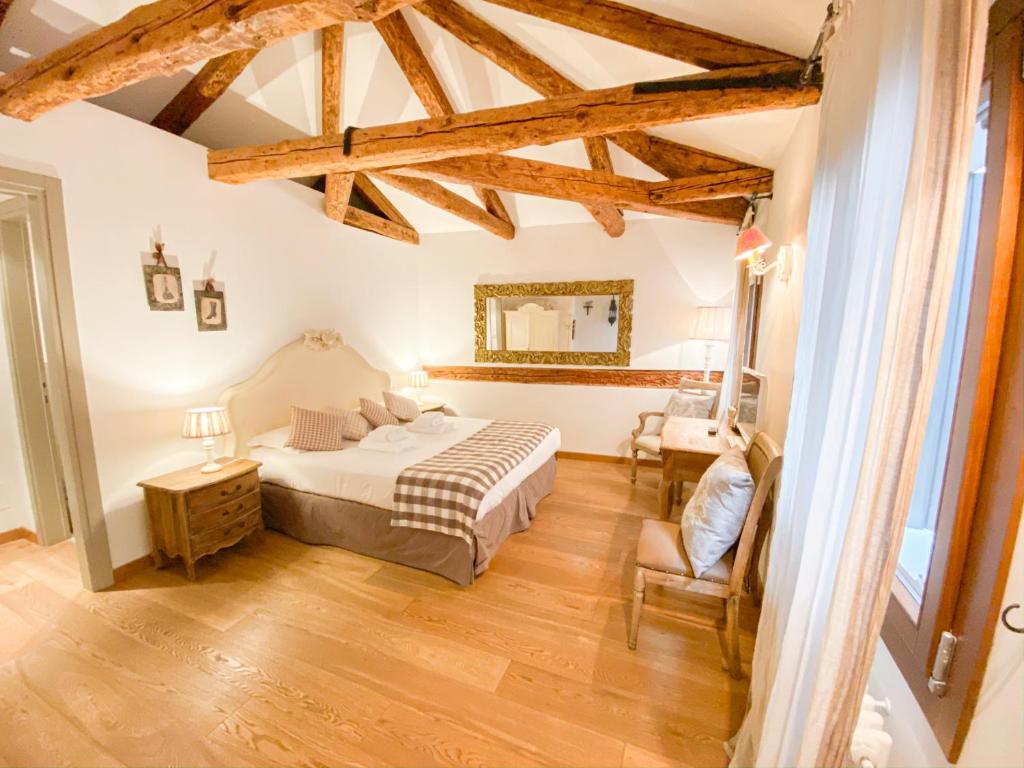 威尼斯的住宿－利哥萊托魅力酒店，一间卧室,卧室内配有一张床和一把椅子