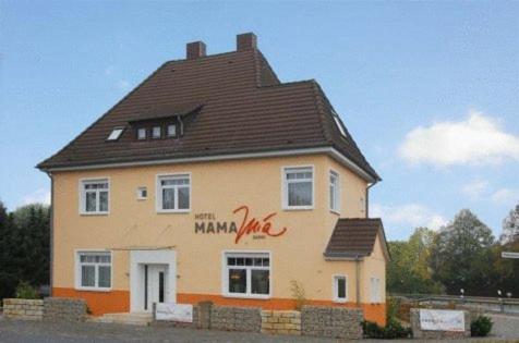 a large house with a black roof at Adam Hotel in Giesen
