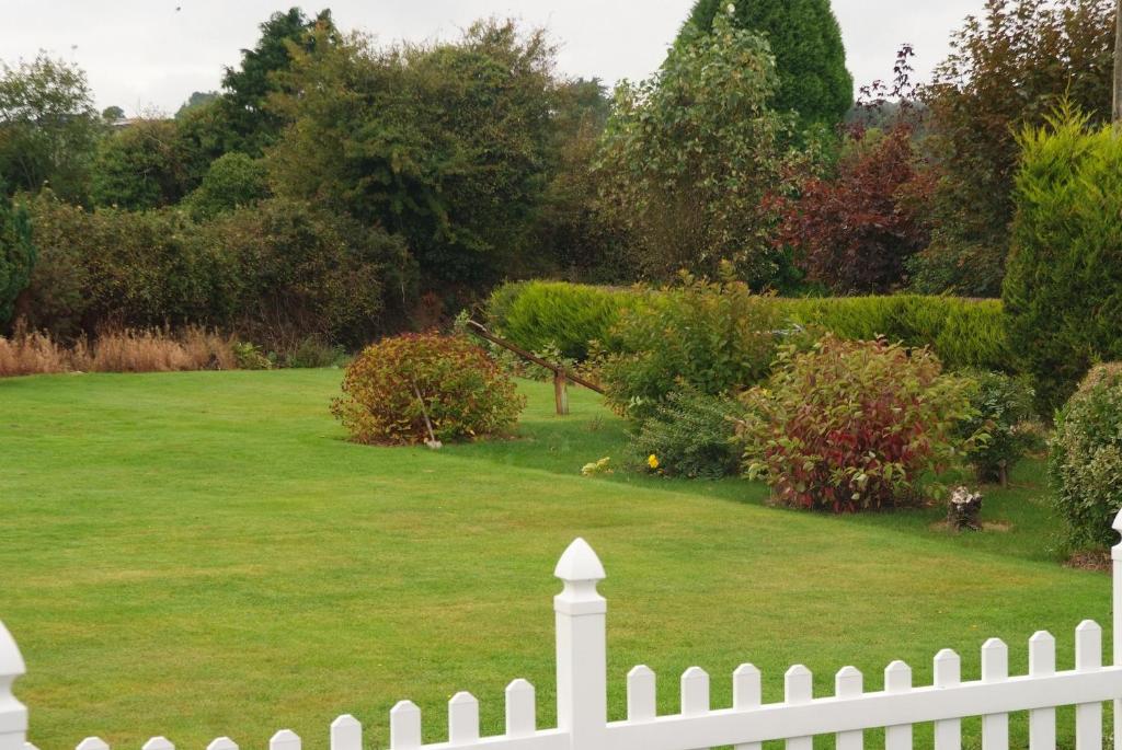 a white picket fence in front of a yard at Gormans Country Home in Killarney