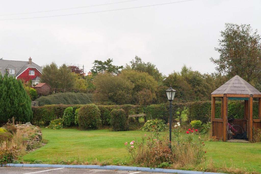 a gazebo in the middle of a garden at Gormans Country Home in Killarney