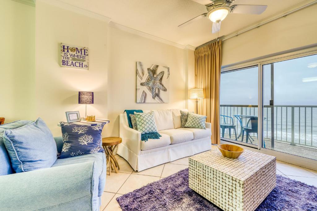 a living room with a couch and a table at Tradewind 1204 in Orange Beach