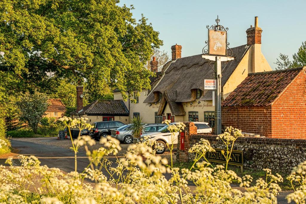 a building with a clock on the side of it at Pitch Perfect Glamping Norfolk in Little Hautbois