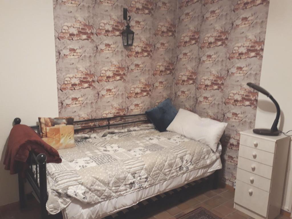 a bedroom with a bed and a dresser at One-bed room Mariensee in Neustadt am Rübenberge