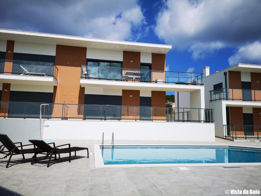 a view of a building with a swimming pool at Vista da Baia in Salir do Porto