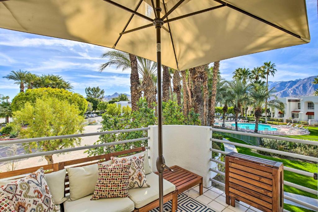 a patio with a bench and an umbrella at Chic Palm Springs Retreat with View Near Escena Golf in Palm Springs