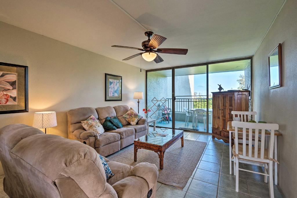 a living room with a couch and a ceiling fan at Hilo Condo with Pool Steps from Carlsmith Beach Park in Hilo