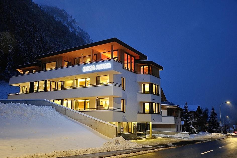 a large building in the snow at night at Chasa Altana in Ischgl