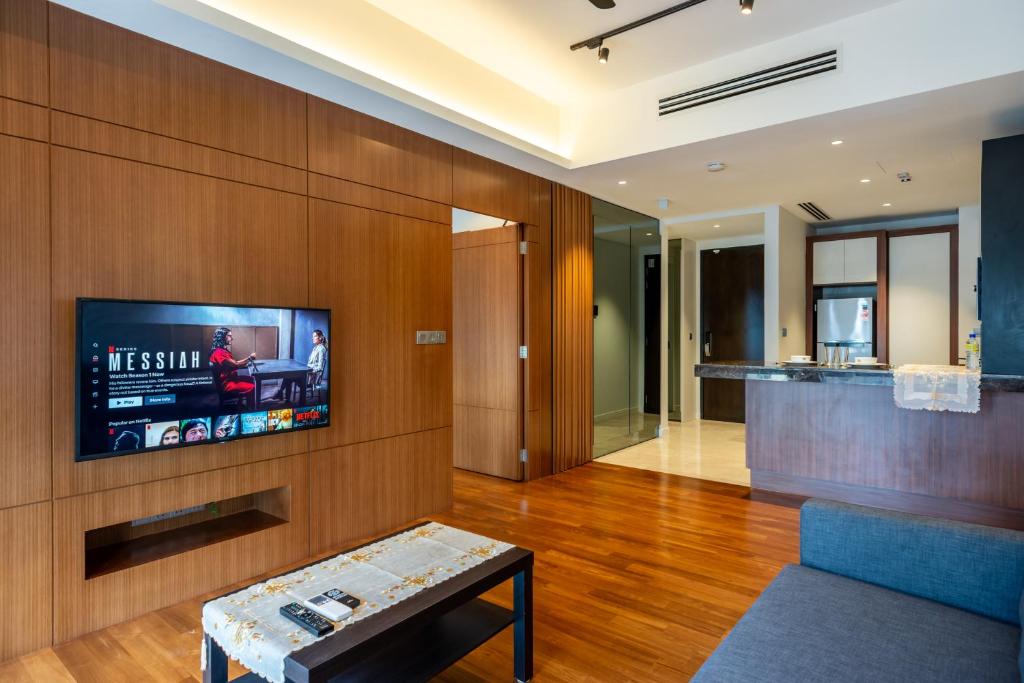 a living room with a tv on a wall at Anggun Residences Luxe in Kuala Lumpur
