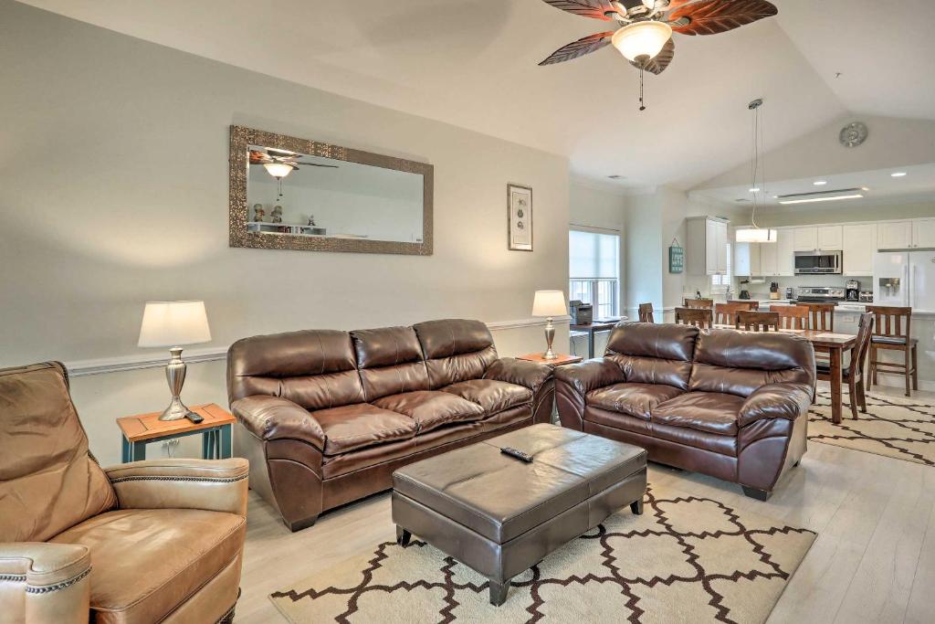 a living room with leather furniture and a dining room at Golfers Paradise Myrtle Beach Condo Near Beach! in Myrtle Beach