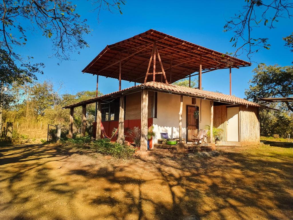 a small house with a thatched roof at Casa Ital-Tico, Playa Negra in Playa Negra