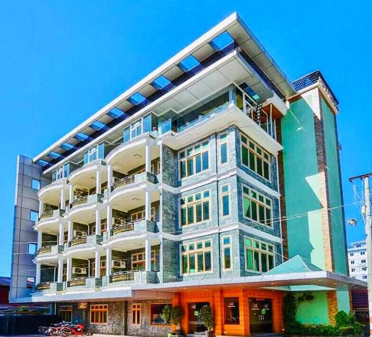 a large building with a lot of windows at Shwe Kyun Hotel in Taunggyi