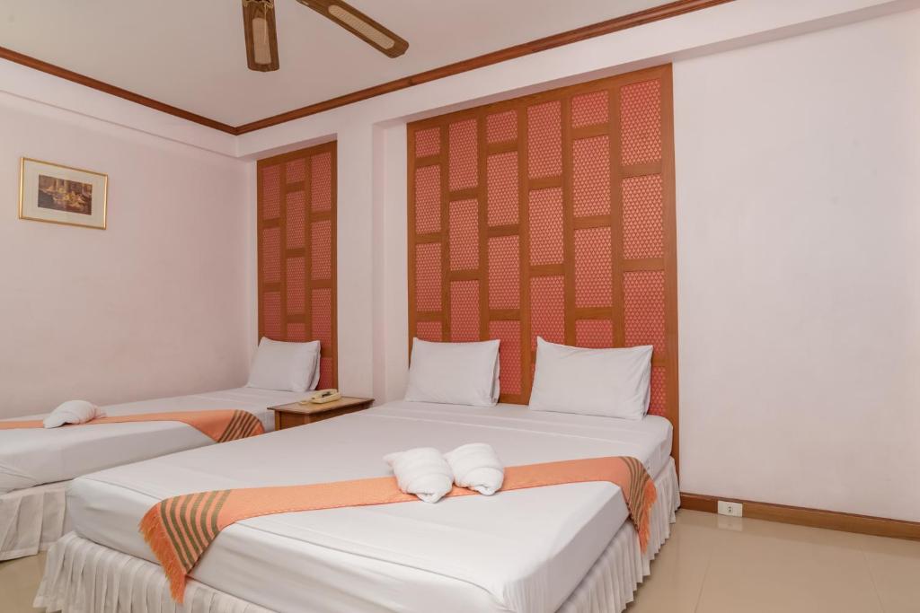 Postel nebo postele na pokoji v ubytování New Siam III Guest House