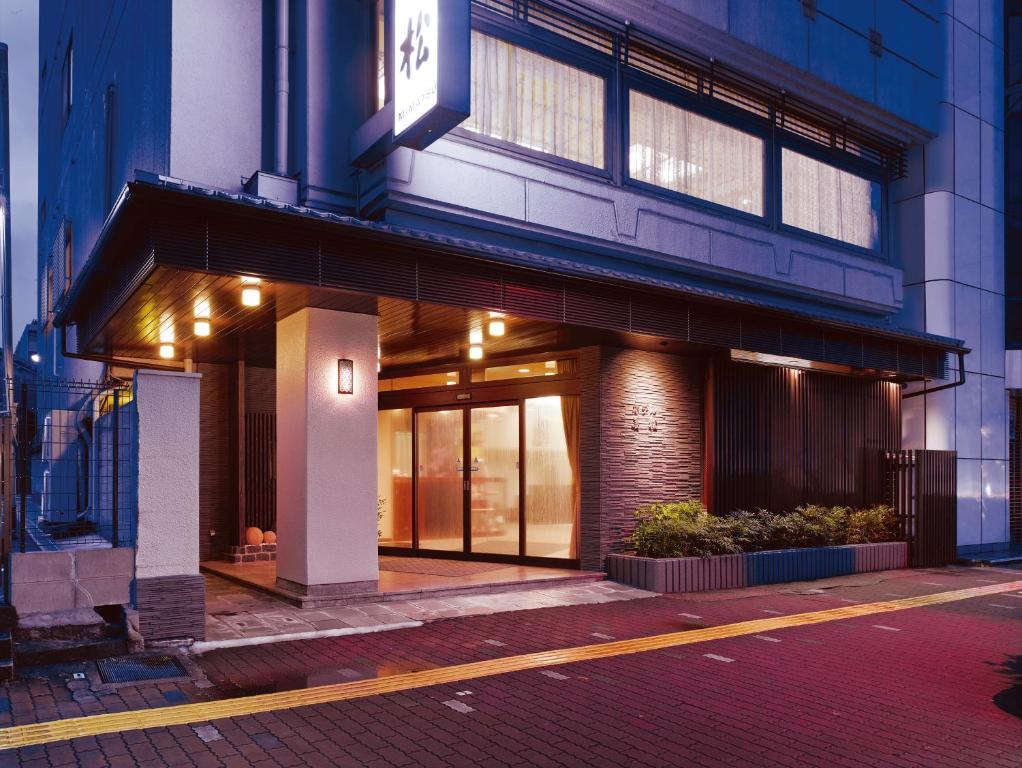 a building with a sign on the front of it at Hotel Mimatsu in Nara