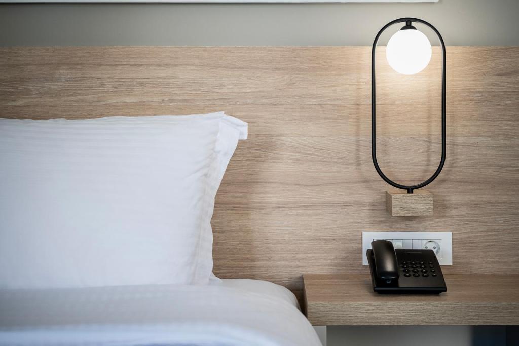 Postel nebo postele na pokoji v ubytování Epavli Boutique Hotel