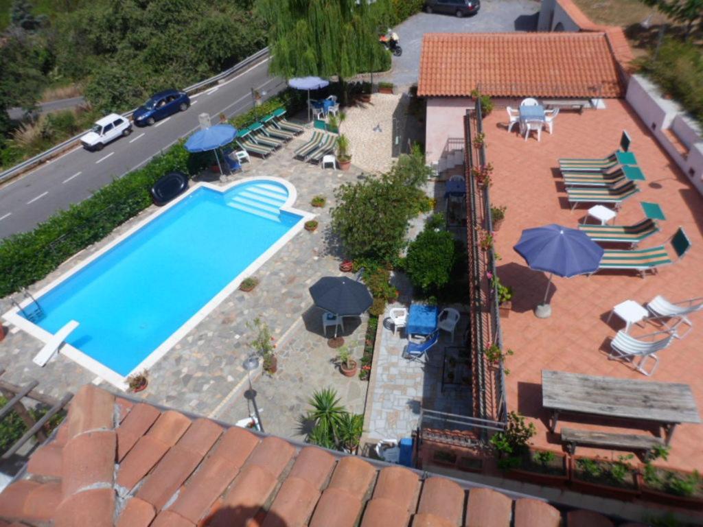 an overhead view of a swimming pool with chairs and umbrellas at Bed & Breakfast Laino in Maratea