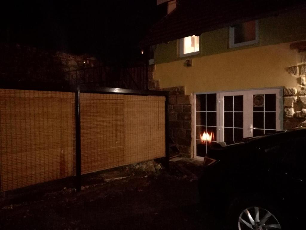 a car parked in front of a house at night at MotoHostel Wolter - apartmán Leme in Všeň