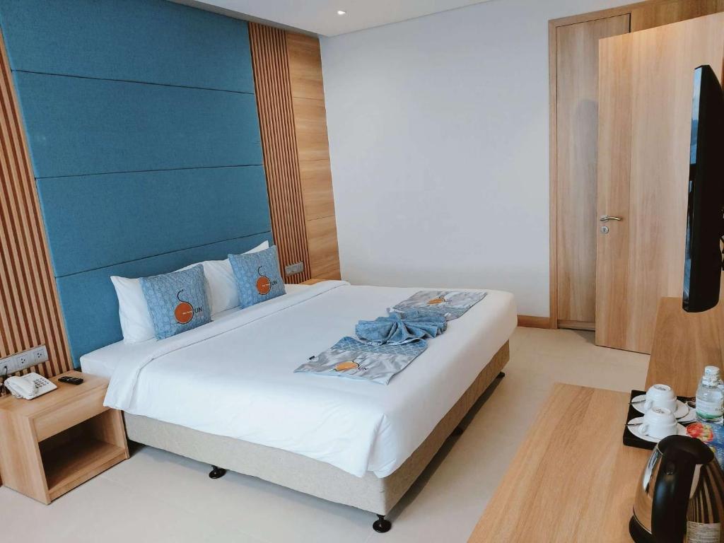 Postel nebo postele na pokoji v ubytování Sun Kiss Hotel