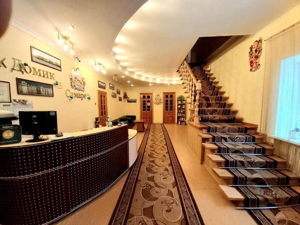 a restaurant with a long hallway with a stair case at Domik v Samare Hotel in Samara