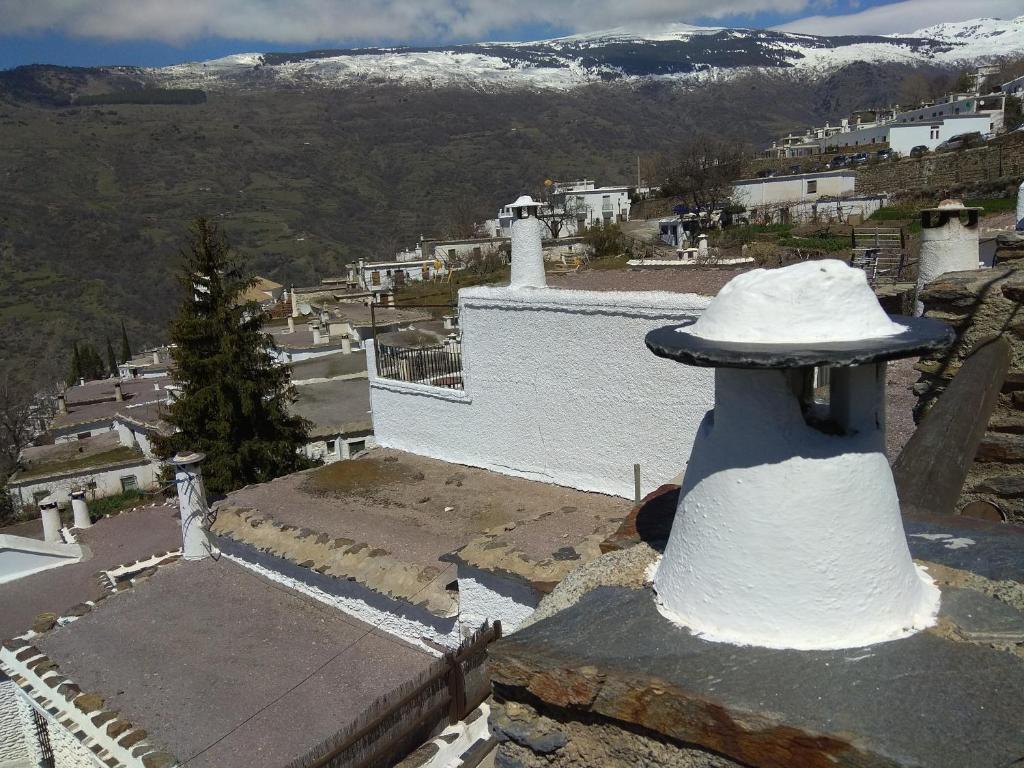 a view of a town with a lighthouse on a building at Una joya en la Alpujarra in Bubión