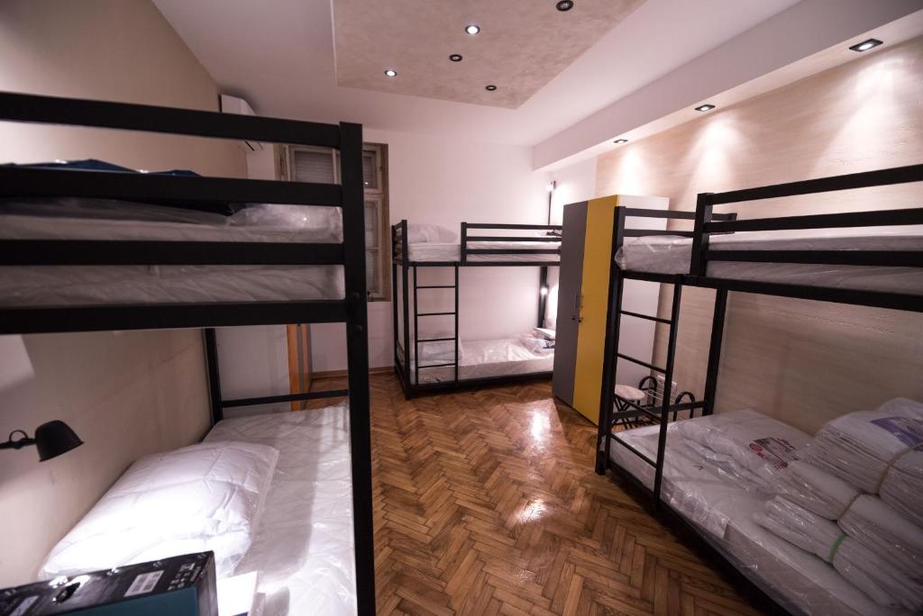 a room with three bunk beds in it at Hostel Evropa in Nikšić