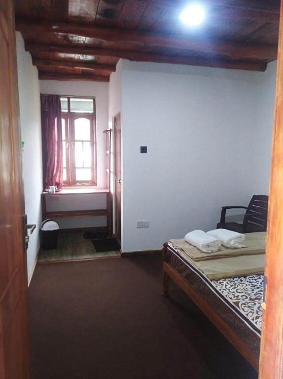 Postel nebo postele na pokoji v ubytování DREAM Hill HOMESTAY NUWARA ELIYA
