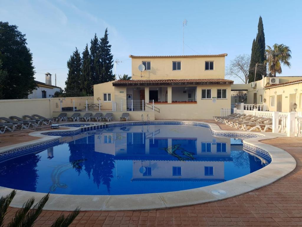 a swimming pool in front of a house at Casa Robion in Godelleta